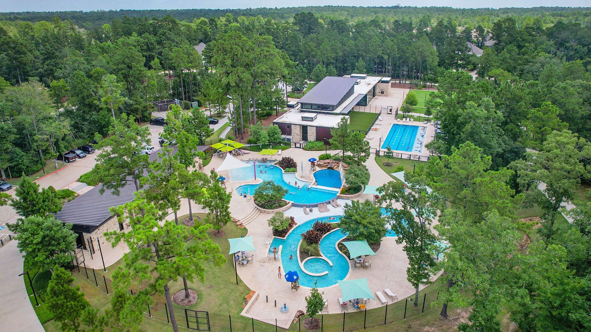 Discover opulent pool features amidst lush greenery in The Woodlands Hills. Elegant design harmonizes with nature.