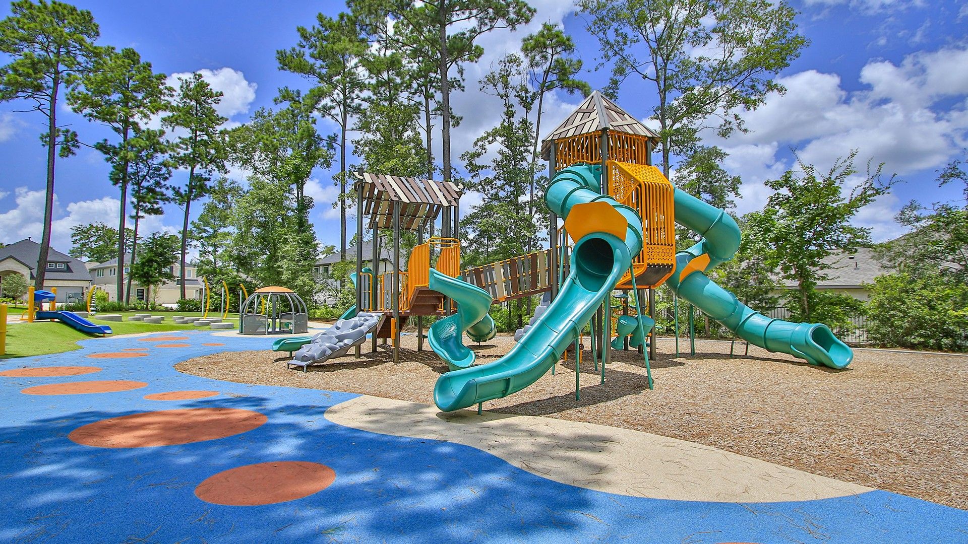 Explore The Woodlands Hills with its vibrant playground, featuring intricate slides and natural surroundings.