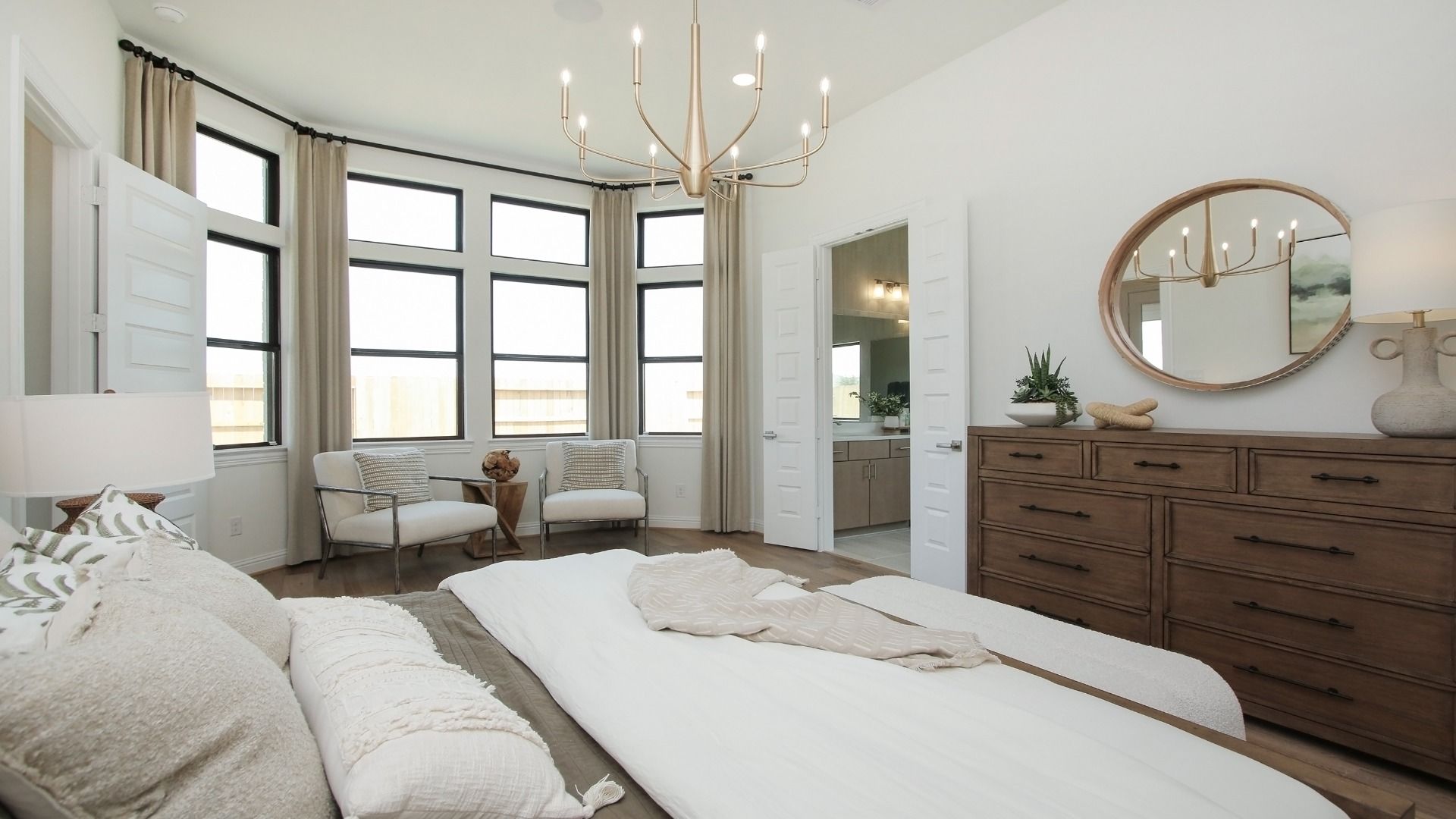Experience sophistication with high ceilings and abundant natural light in Sunterra community's exquisite bedroom.