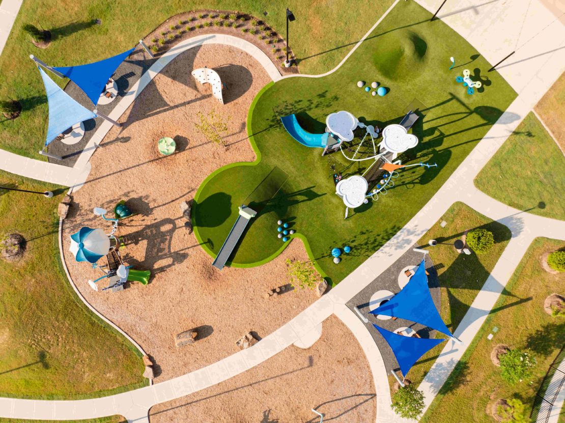 Experience innovative design with modern play structures and striking blue sails in Sunterra community.