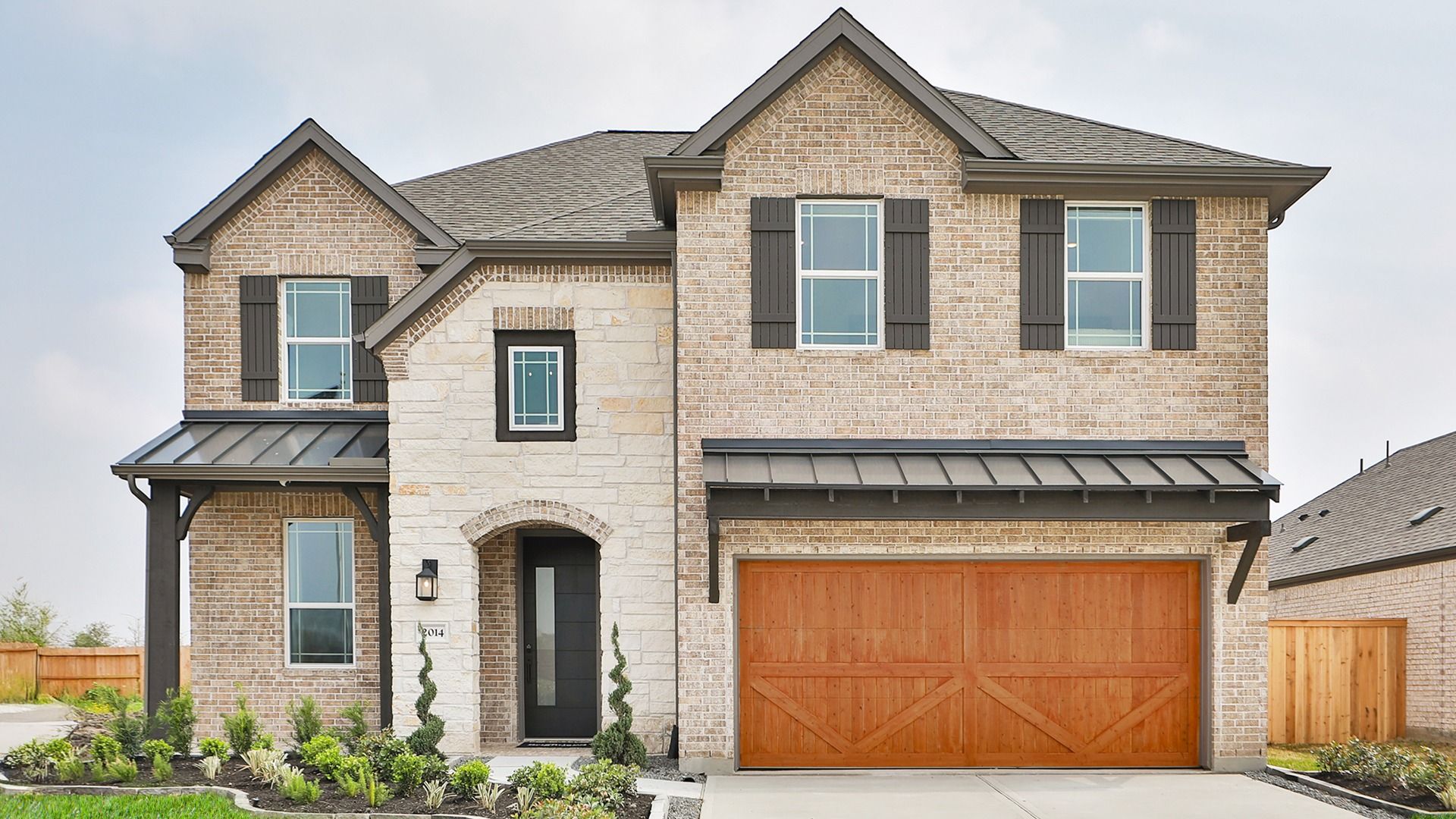 Elegant brick facade with wood garage, refined trim. Nestled in the desirable Park at Eldridge.