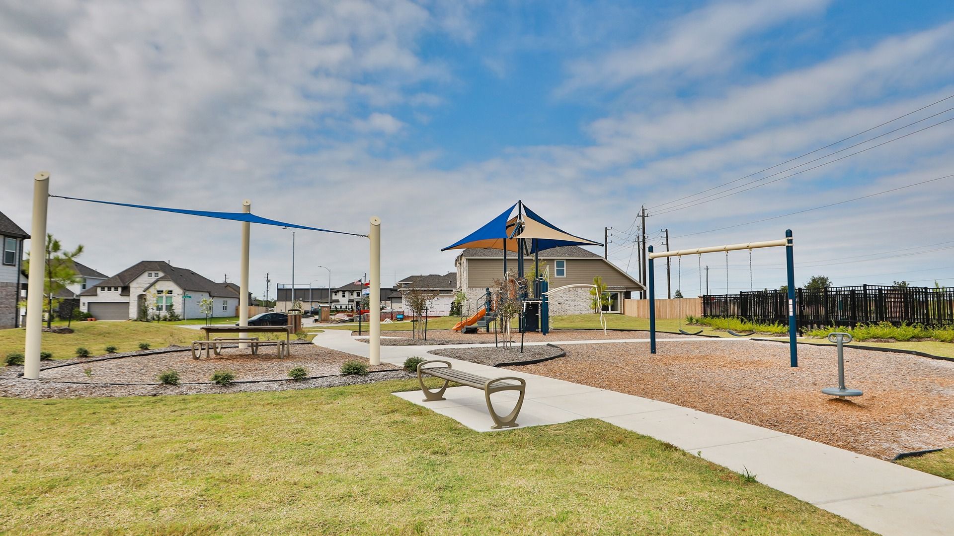 Playground features striking shade canopy and sleek slide, embodying Beamer Villas' refined recreational design.