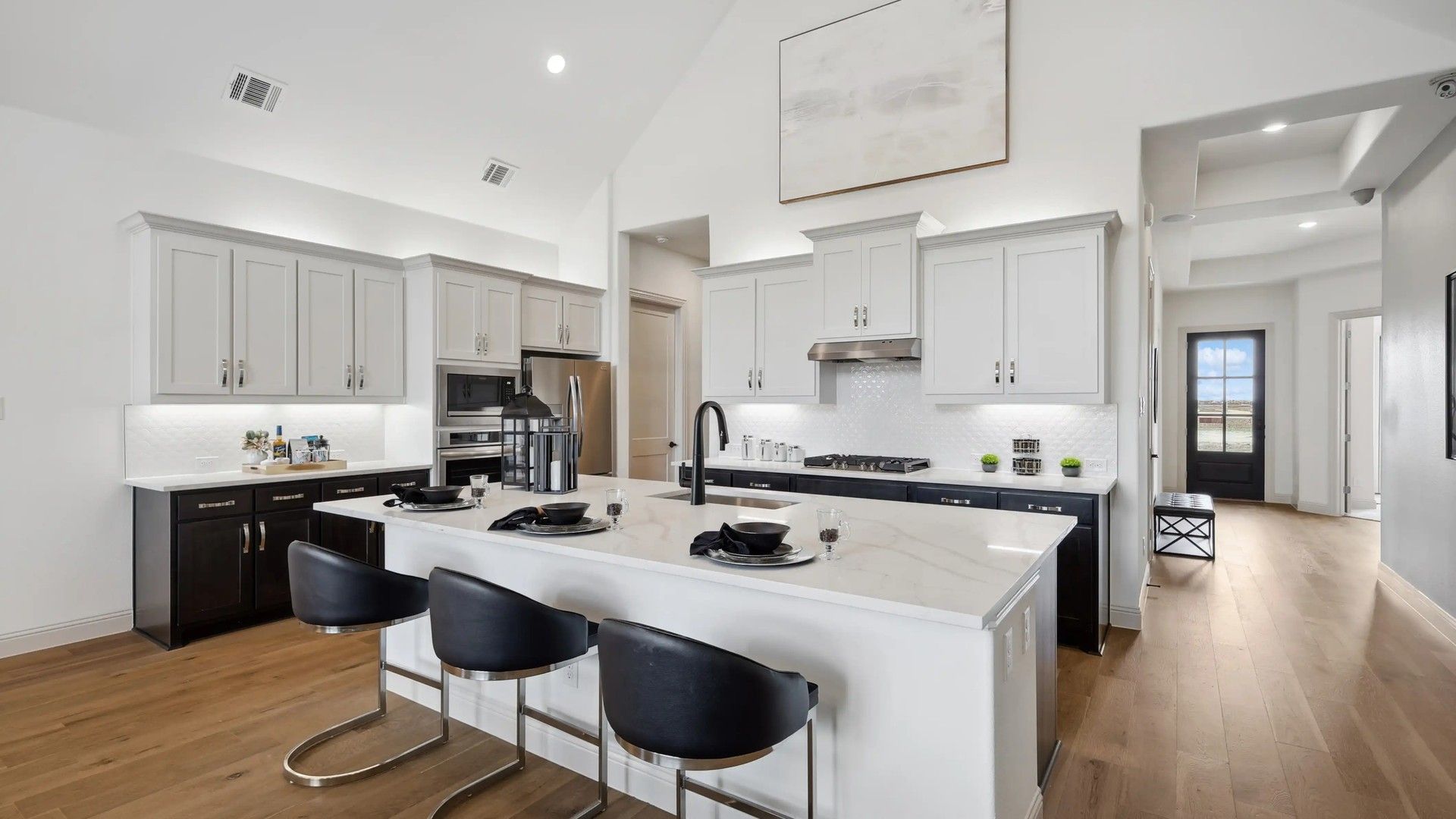 Elegant marble island with state-of-the-art appliances enhances this Westside Preserve kitchen's sophistication.