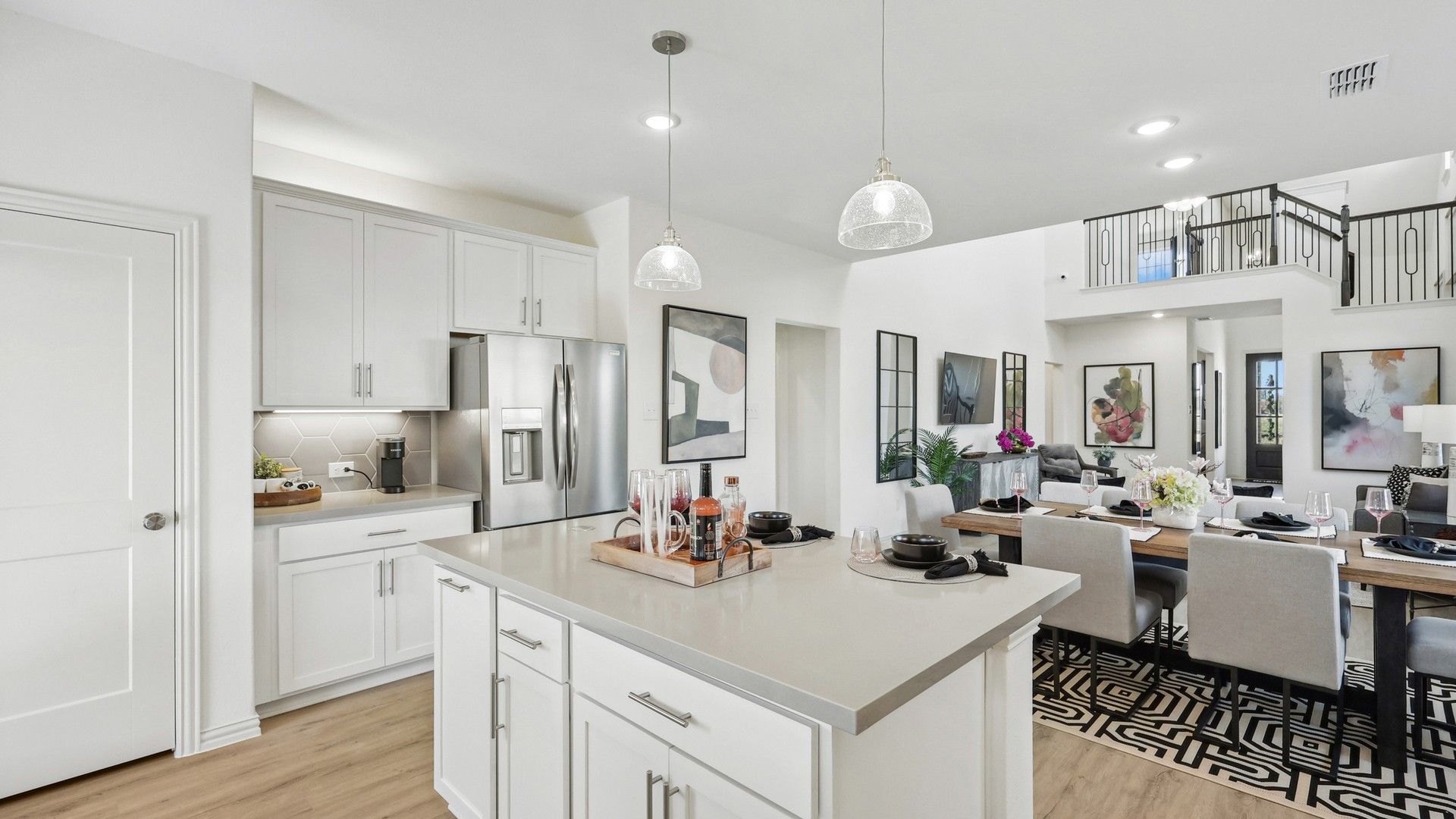 Sleek kitchen and dining with quartz counters, stainless steel, and high ceilings in Bel Air Village.