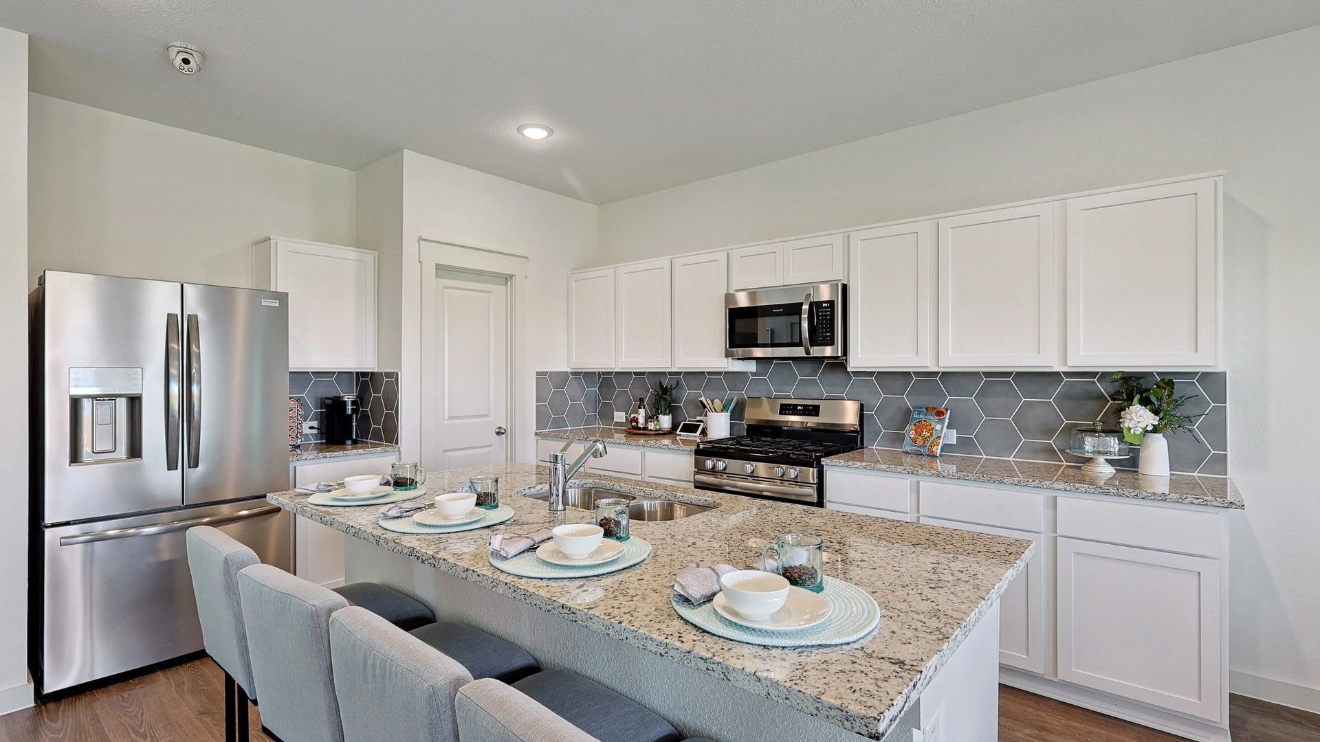 Experience luxury with granite countertops and a striking hexagonal backsplash in Patriot Estates.