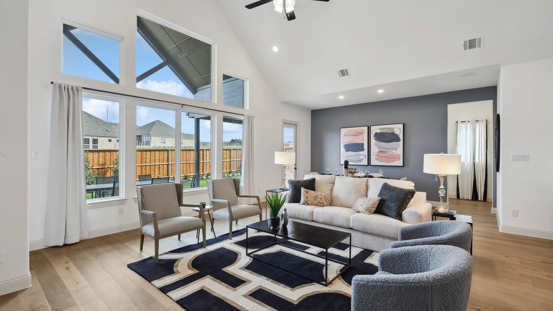 Revel in the high ceilings and expansive windows of this Westside Preserve living room, epitomizing modern elegance.