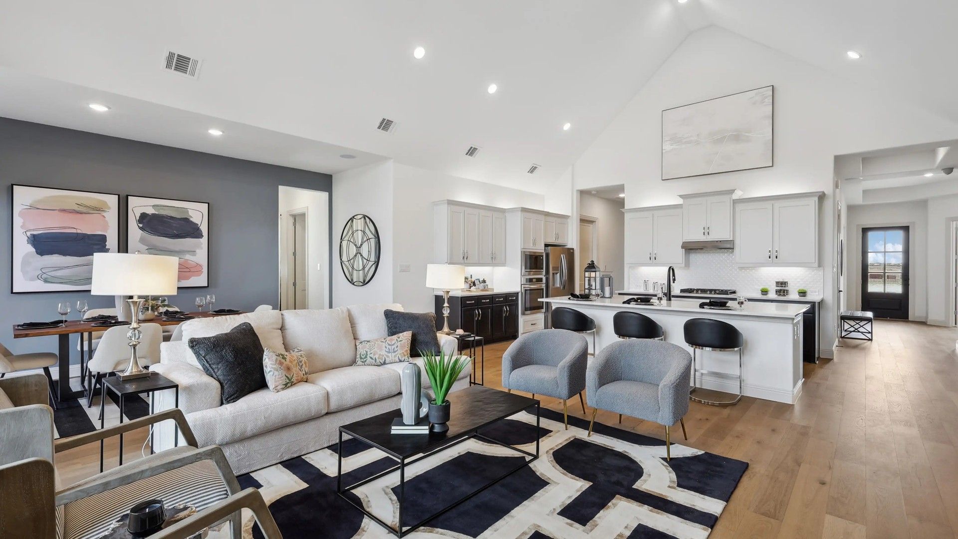 Spacious open-concept layout with vaulted ceilings, chic decor, and premium finishes in Westside Preserve.