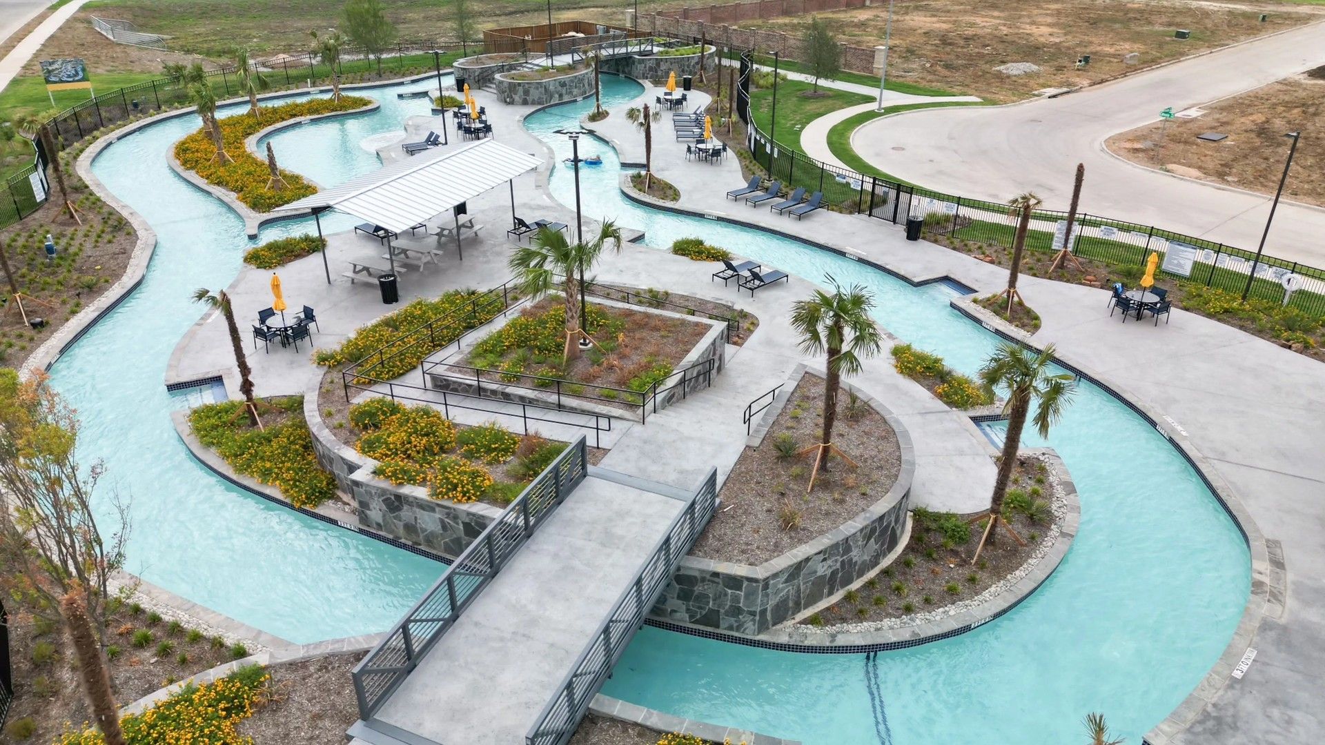 Experience modern elegance with a flowing lazy river and lush landscaping at Wildflower Ranch, Texas.