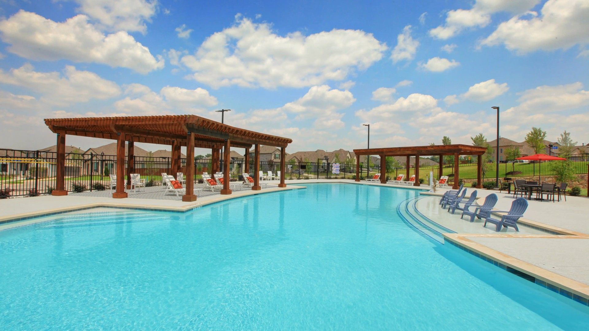 Experience leisure with a pristine pool, stylish wooden pergolas, and plush seating at Thompson Farms.