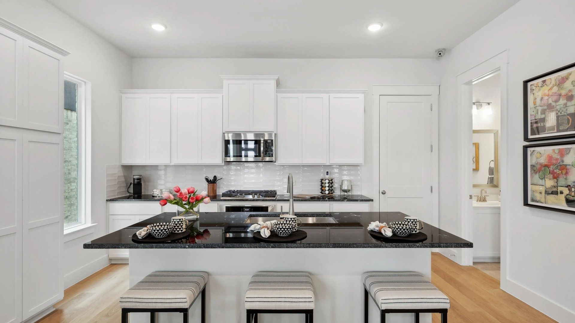 Experience luxury in Collin Creek's kitchen with exquisite granite island and sleek cabinetry.