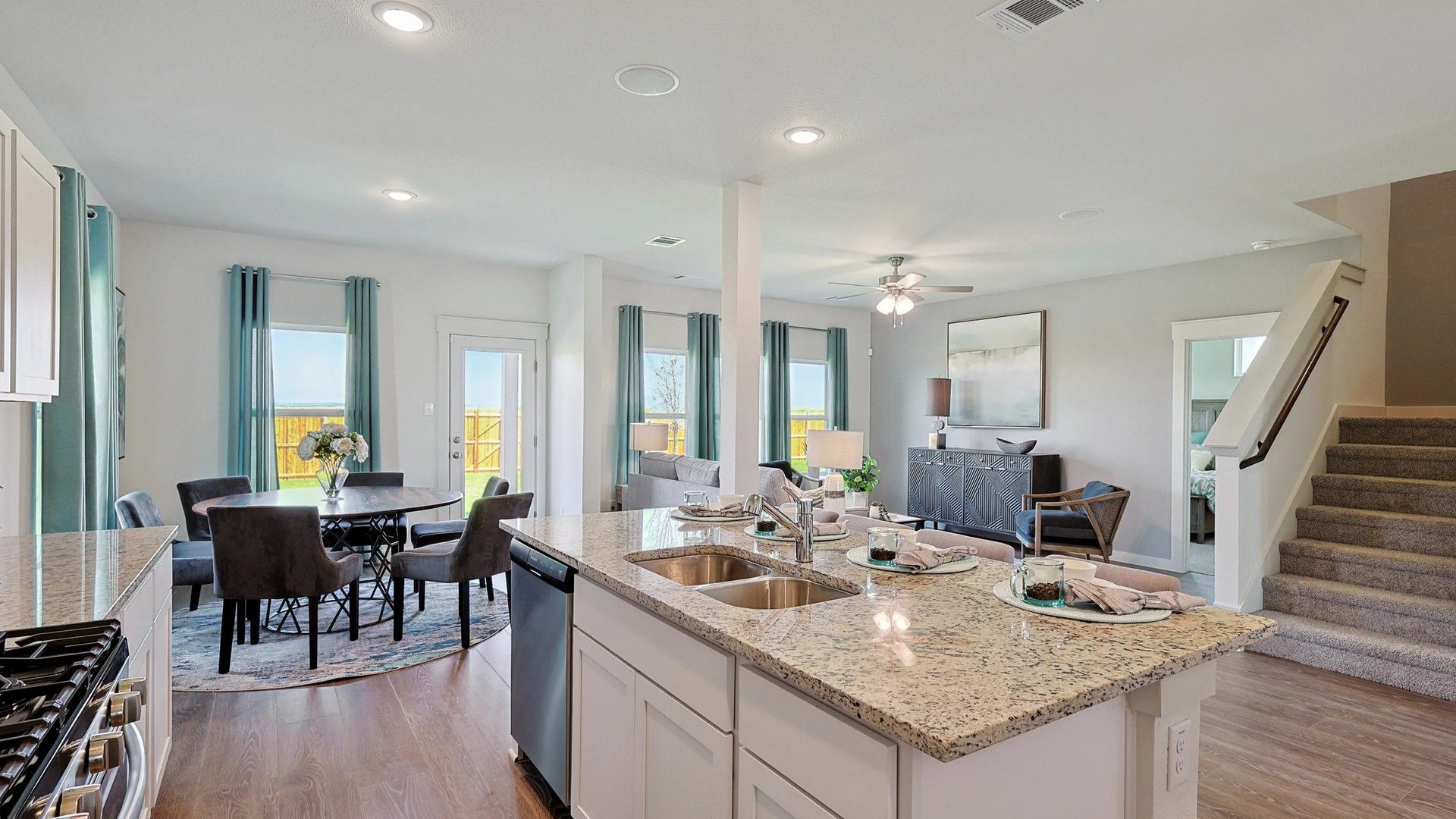 Granite countertops and rich hardwood floors enhance the elegant open layout in this exquisite Patriot Estates home.