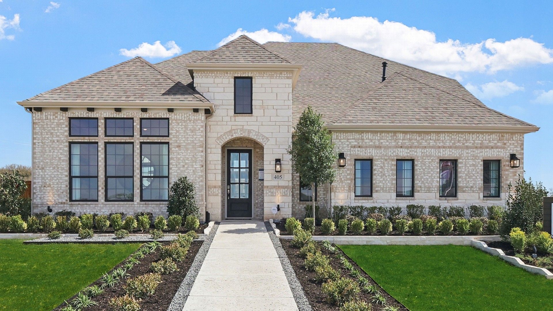 Distinctive brick facade and expansive windows define this exquisite Kelly Ranch residence.