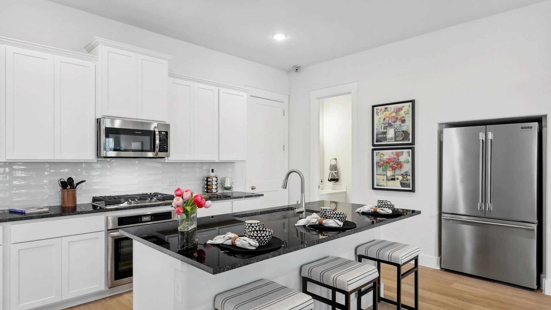 Experience luxury in this kitchen with sleek granite countertops and premium stainless appliances in Collin Creek.