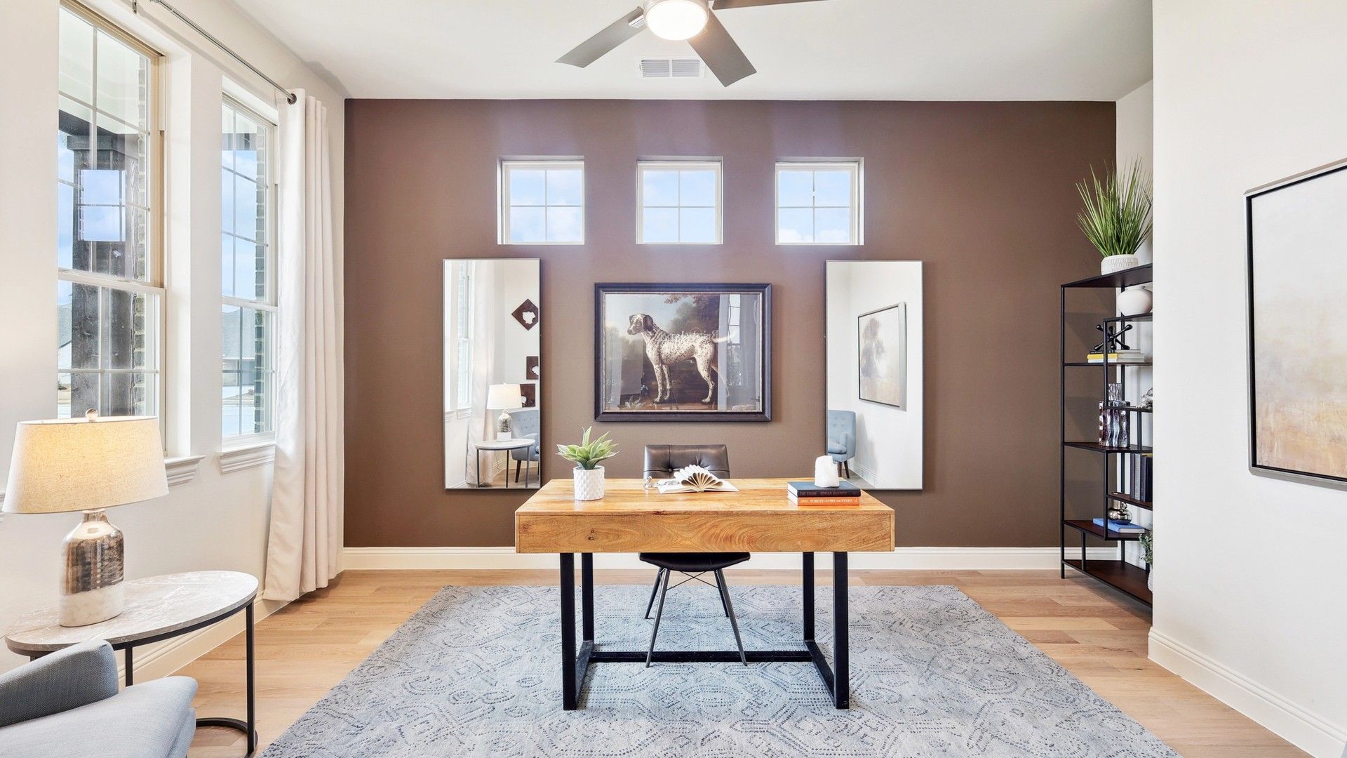 Experience refined elegance with a sleek wood desk, expansive windows, and contemporary design in The Oaks.