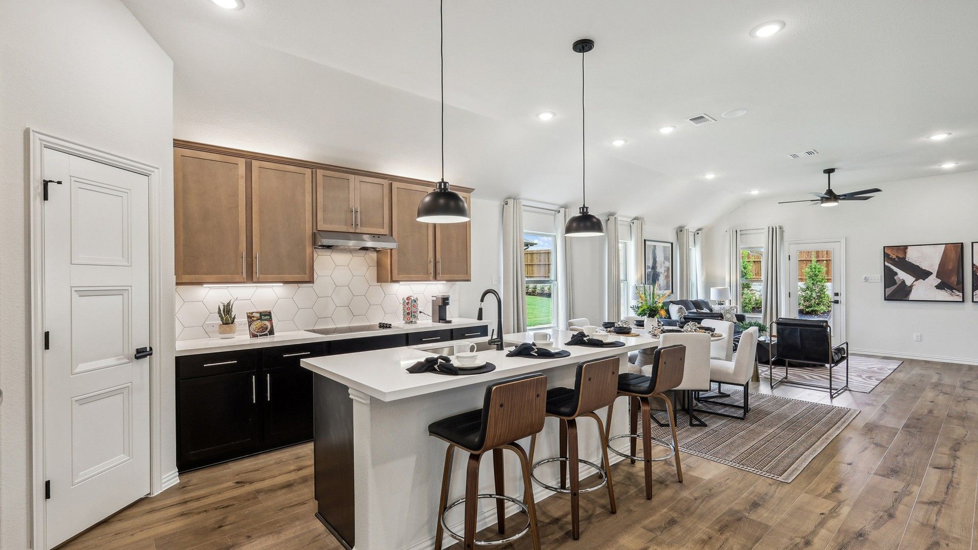Elegant kitchen with hexagonal tile backsplash, wooden accents, and open-plan design in Churchill, Texas.