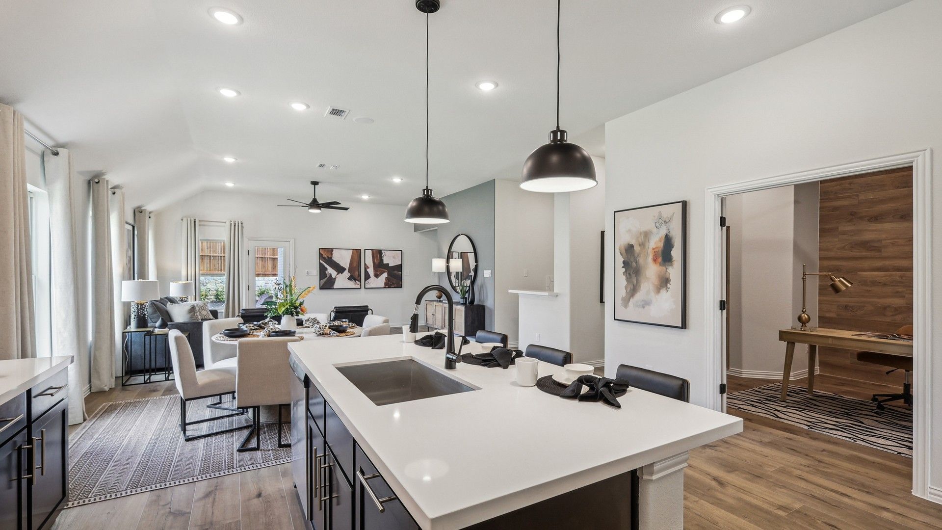 Discover exquisite design in this Churchill home, featuring a sleek island and premium wood floors.