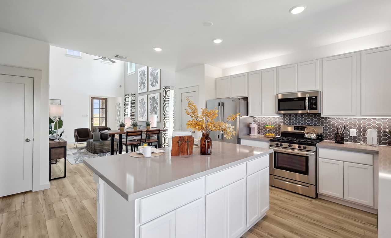 Exquisite kitchen island, hexagonal backsplash enhance elegance in Walden Pond residence.
