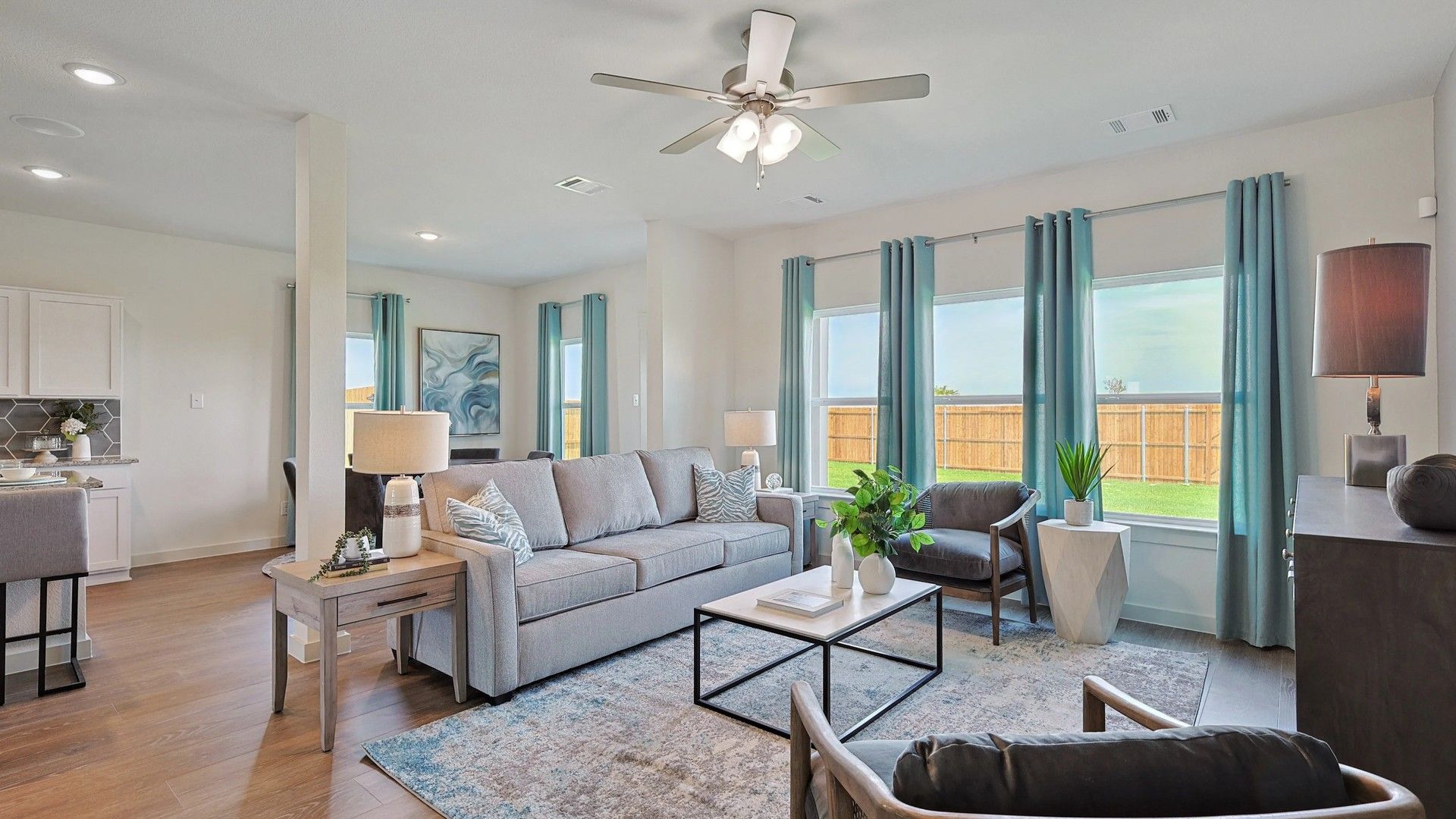 Luxurious living space with expansive windows, airy layout, and exquisite wood floors in Patriot Estates.