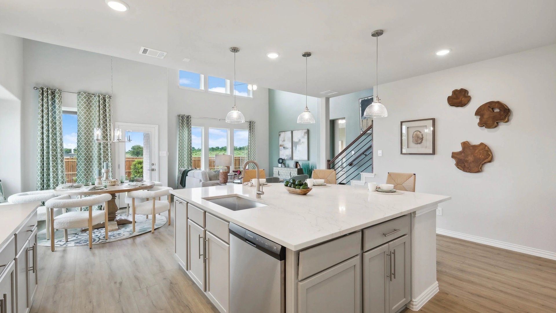 Expansive kitchen with marble countertops and elegant pendant lighting in Fort Worth's Hulen Trails.
