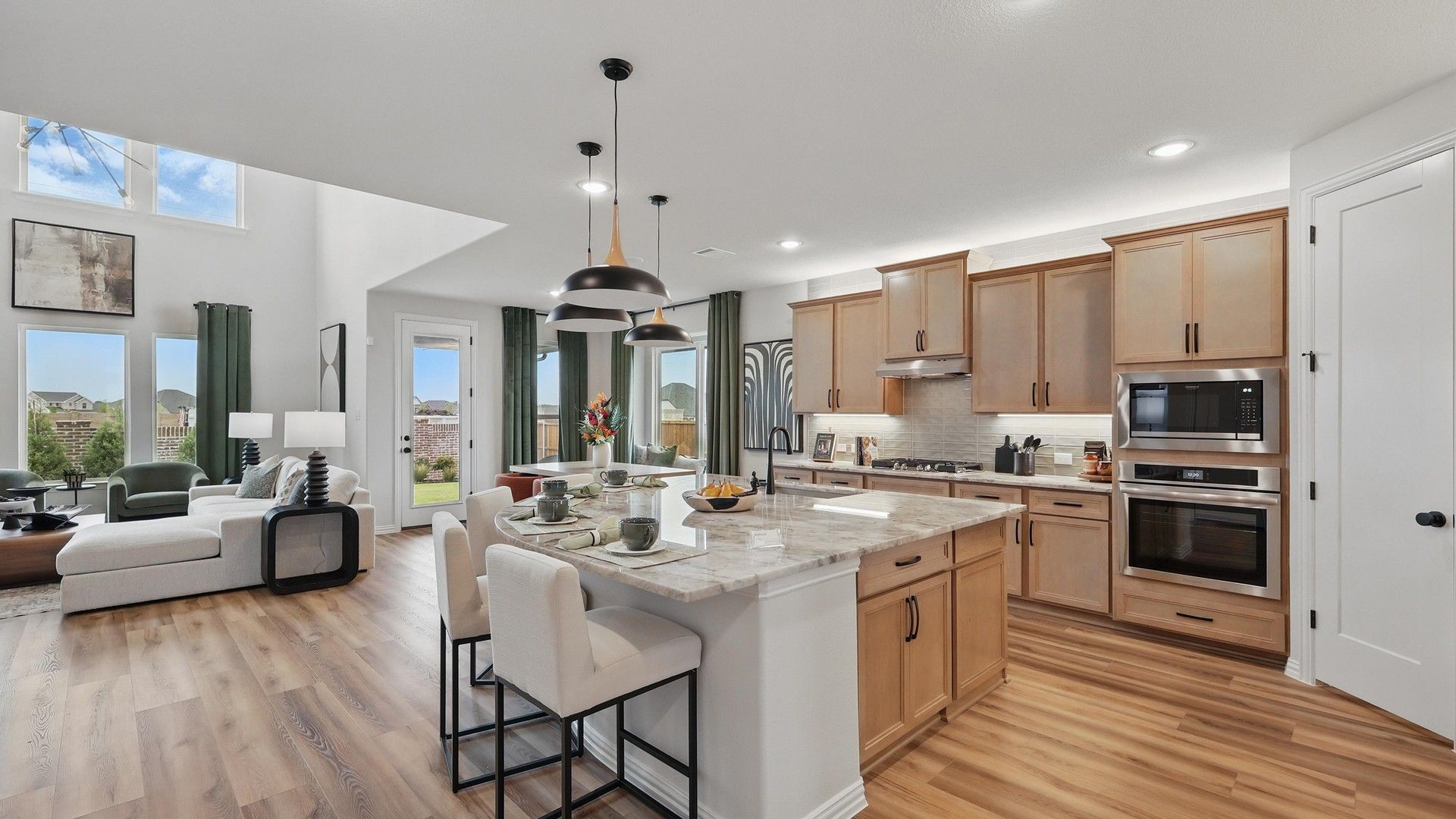 Exquisite open-plan design with chic wood cabinetry and elegant stone countertops in Westridge community.