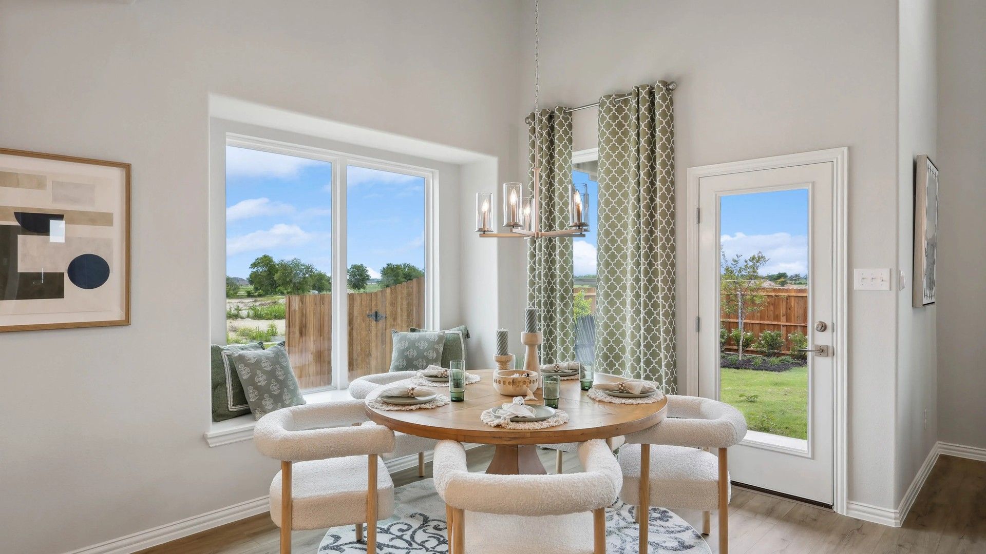 Revel in the plush seating, sleek chandelier, and expansive windows with garden views in Hulen Trails.