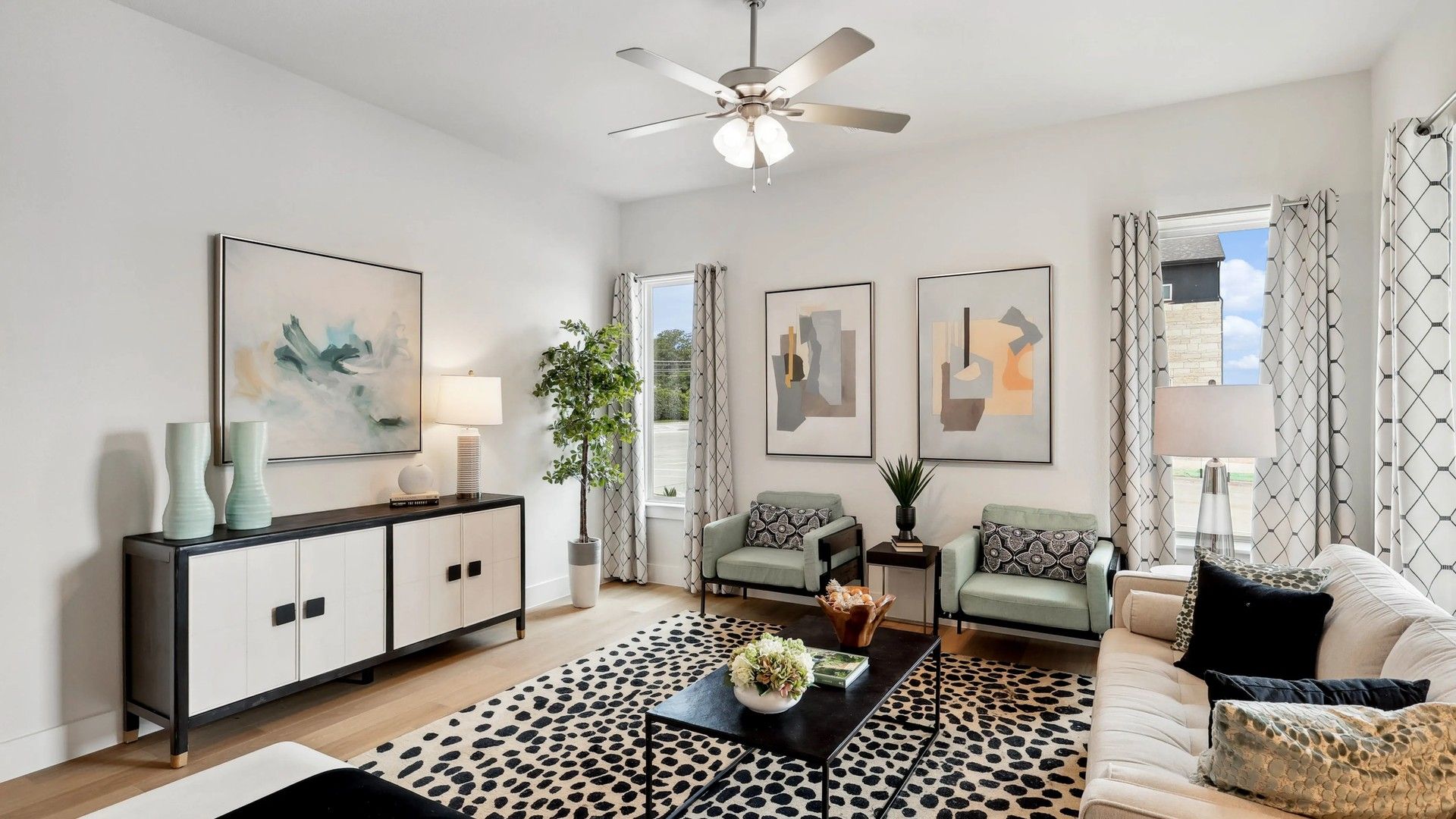 Elegant modern living room with chic artwork, luxurious textiles, and ambient lighting in Collin Creek.