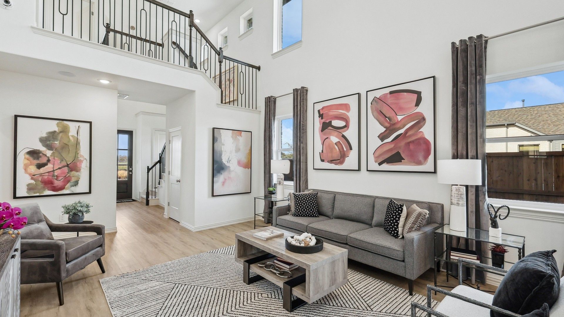 Experience luxury with soaring ceilings, sleek iron railing, and curated artwork in Bel Air Village.