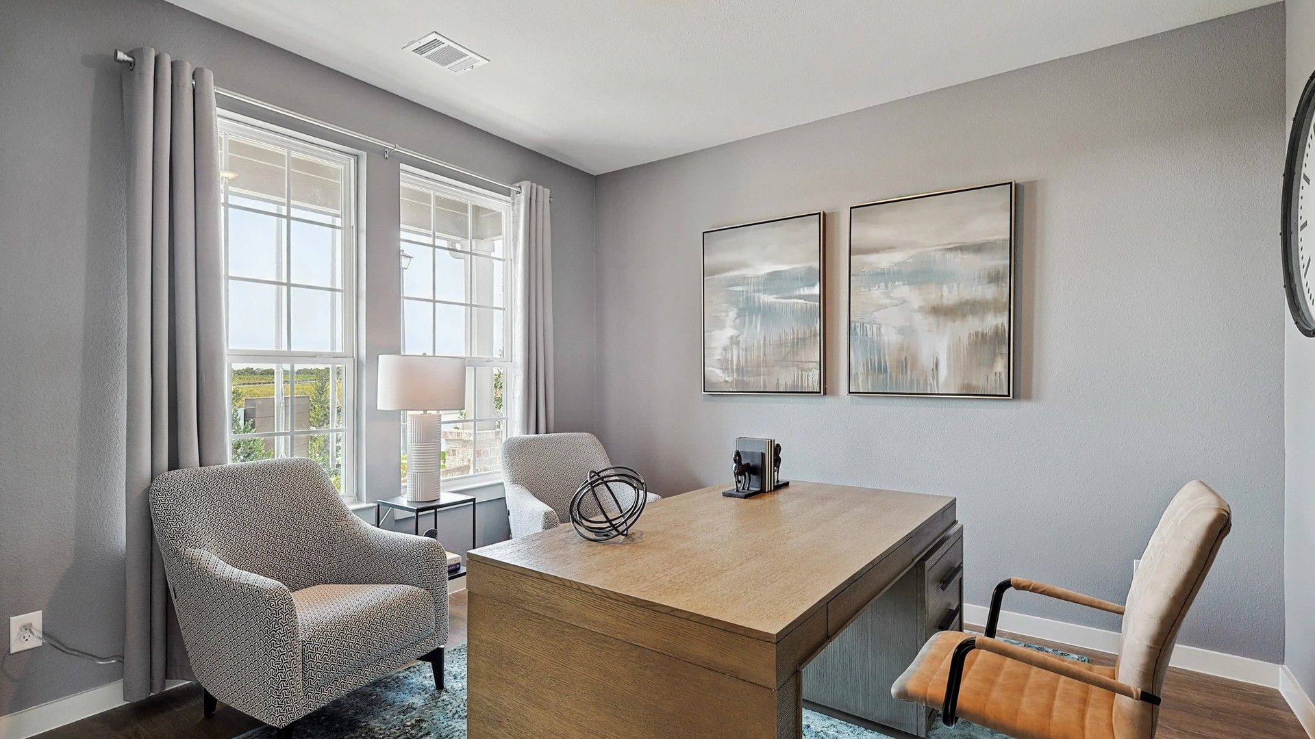 Discover refined elegance with large windows, patterned chairs, and sophisticated artwork in Patriot Estates.