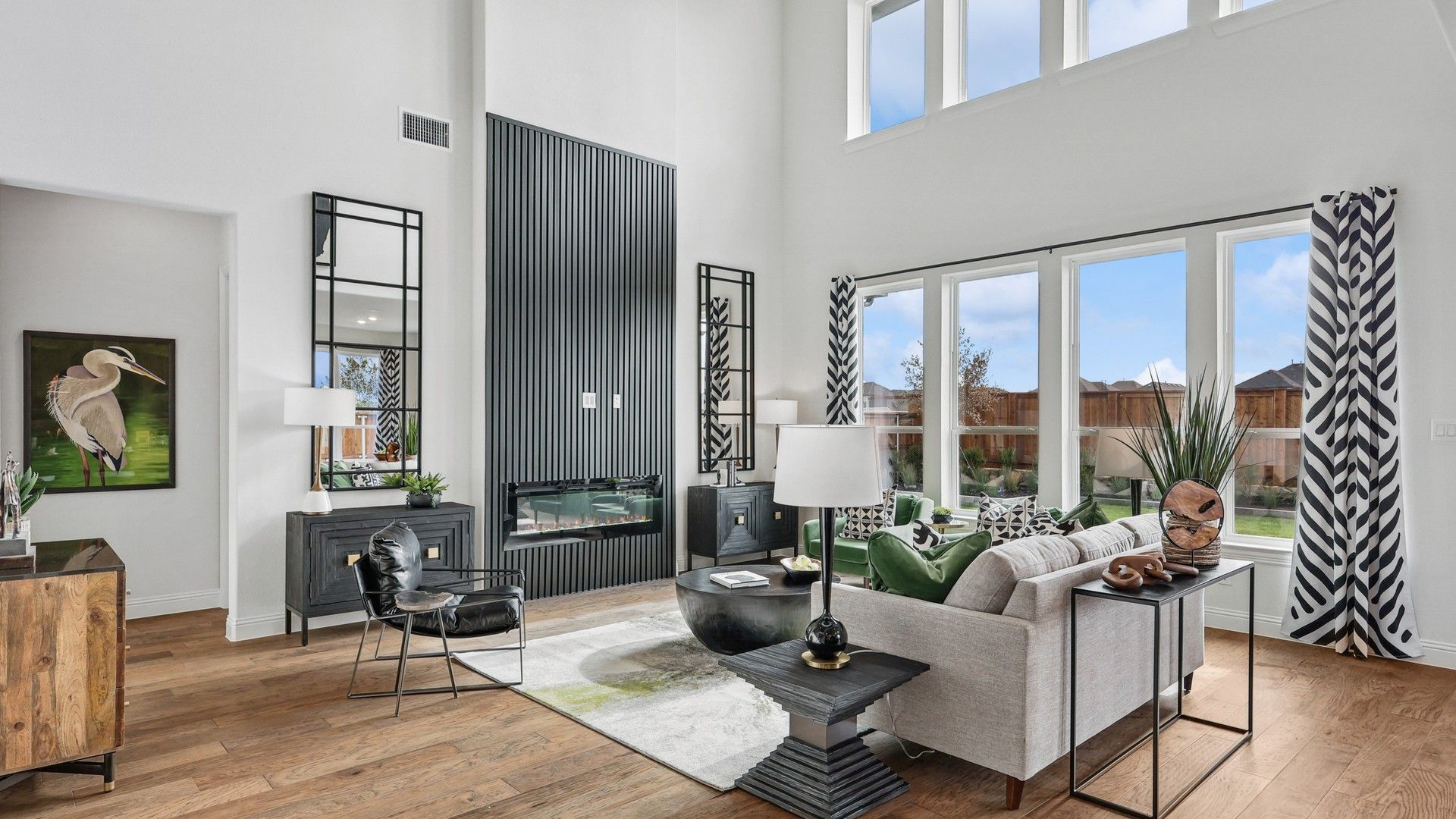 High ceilings and expansive windows enhance the refined living space in Green Meadows, exuding modern luxury.