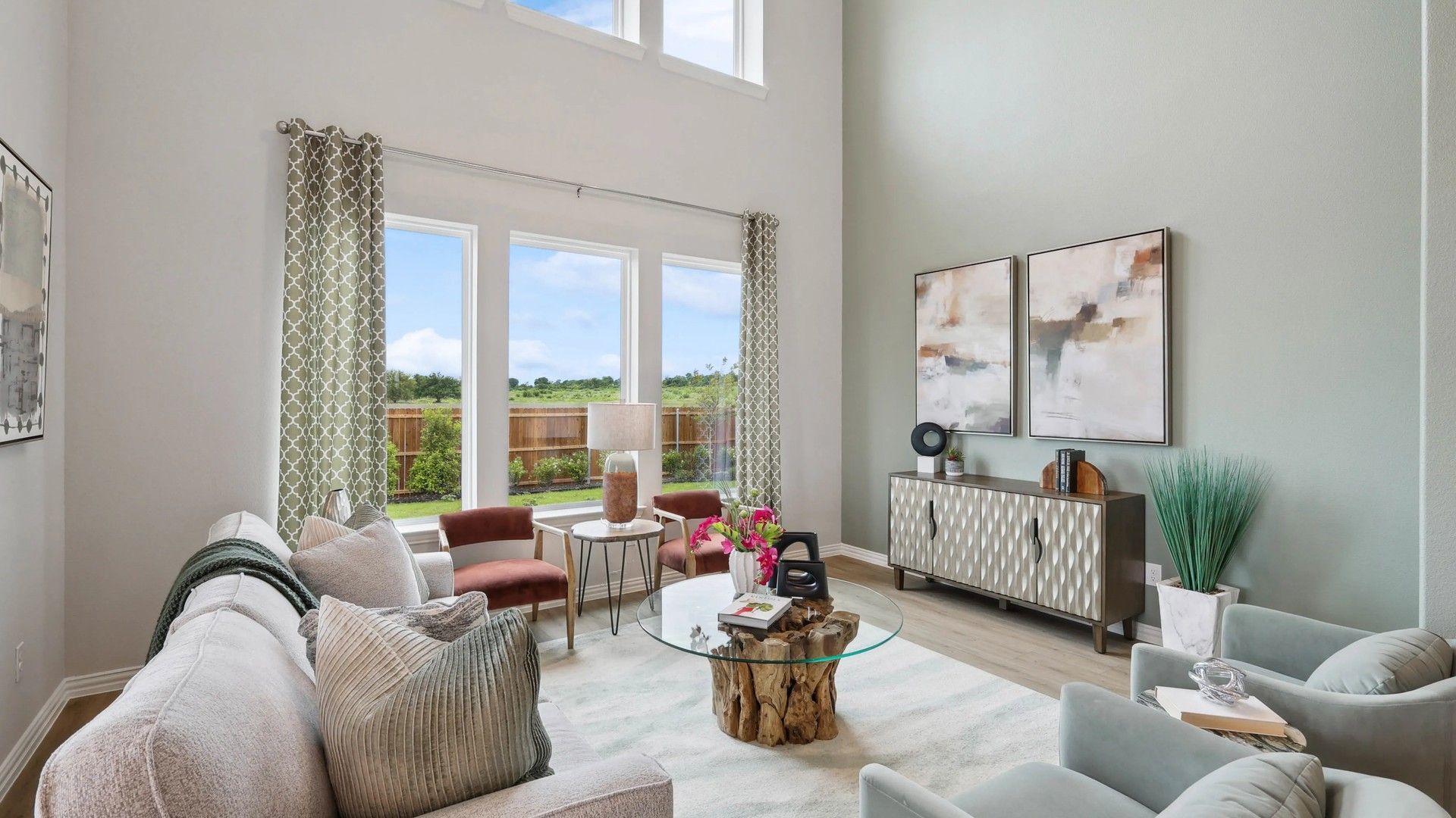 Grand living room with towering windows and sophisticated decor in Hulen Trails.