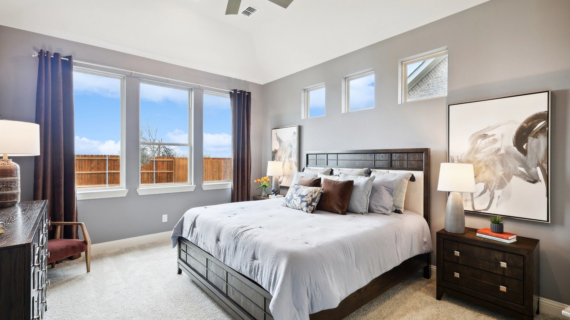 Bask in luxury at The Oaks with plush carpeting, elegant decor, and abundant natural light through expansive windows.