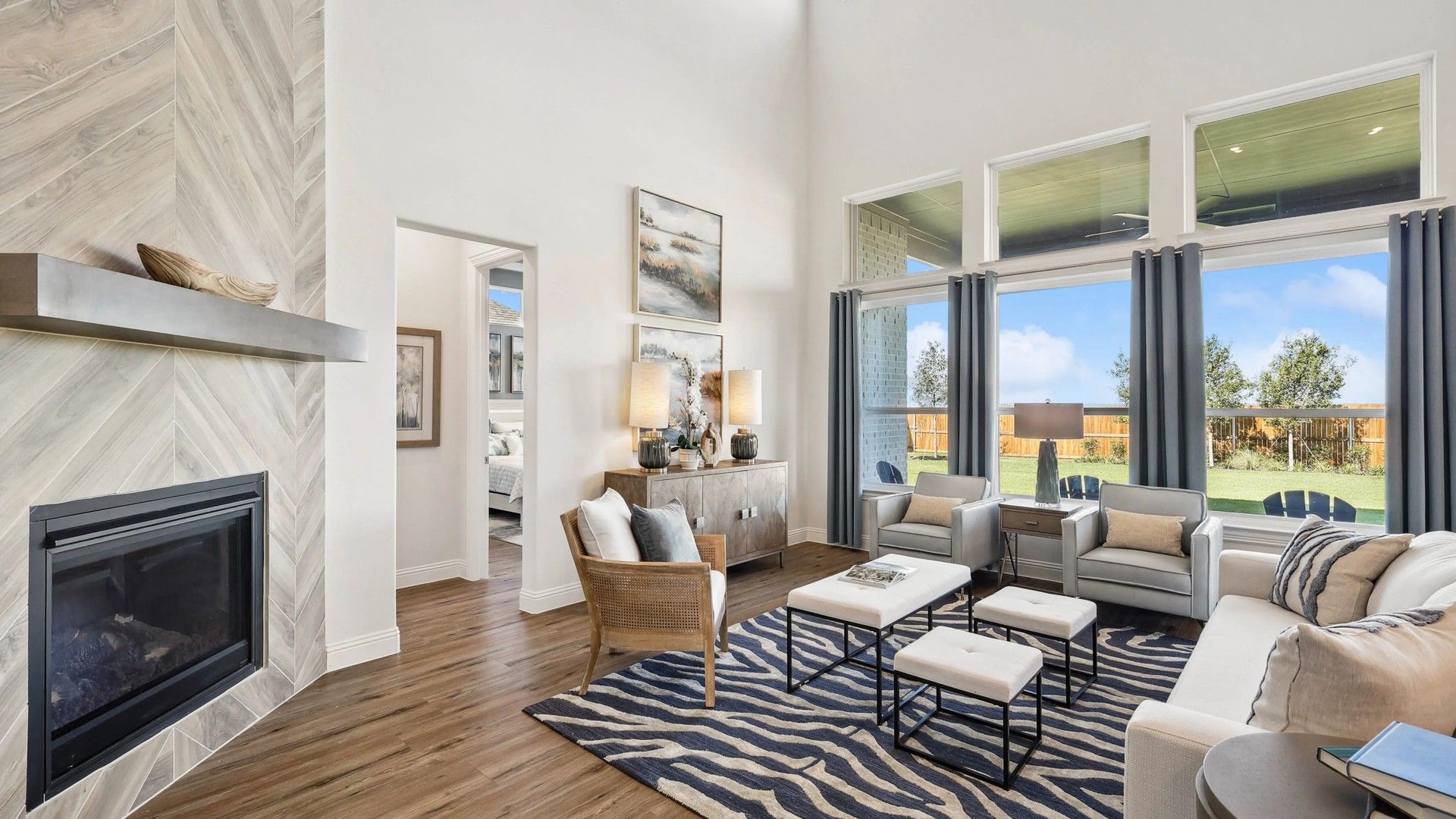 Revel in Ridge Crossing's high ceilings, vast windows, and chic fireplace in this elegant Texas living space.