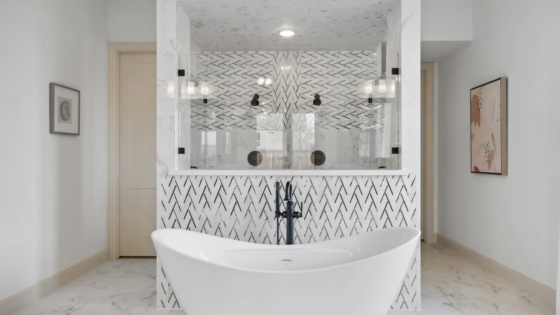 Indulge in opulence with a marble herringbone-tiled shower and elegant freestanding bathtub in Westside Preserve.