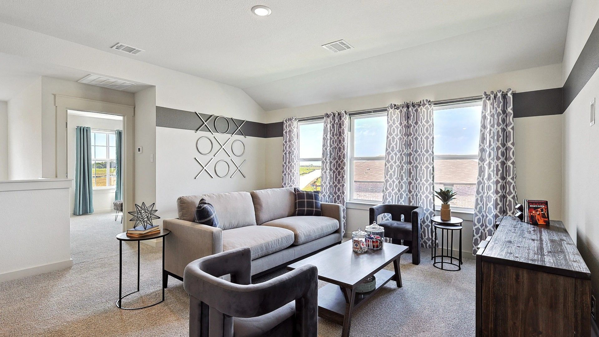 Experience refined elegance with abstract wall art and plush gray furnishings in Patriot Estates.