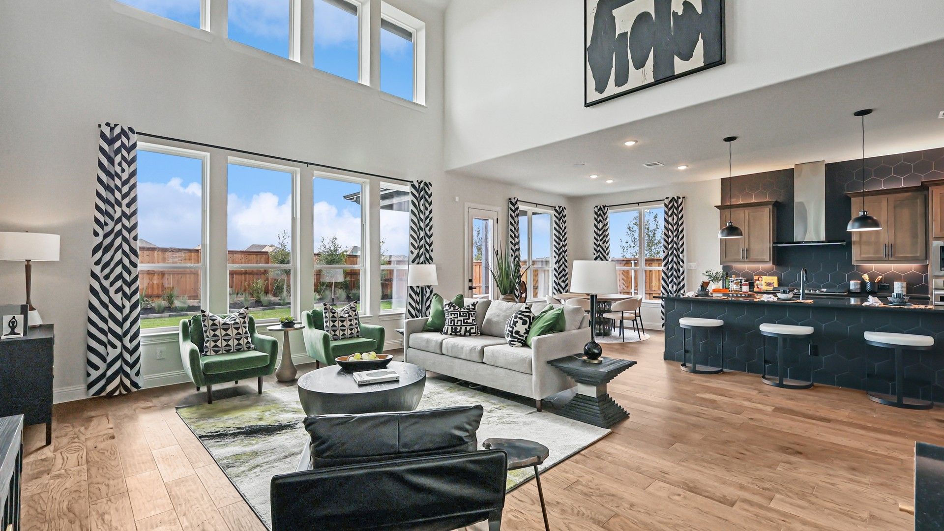 Soaring ceilings and expansive windows amplify light and space, accentuated by chic decor in Green Meadows.
