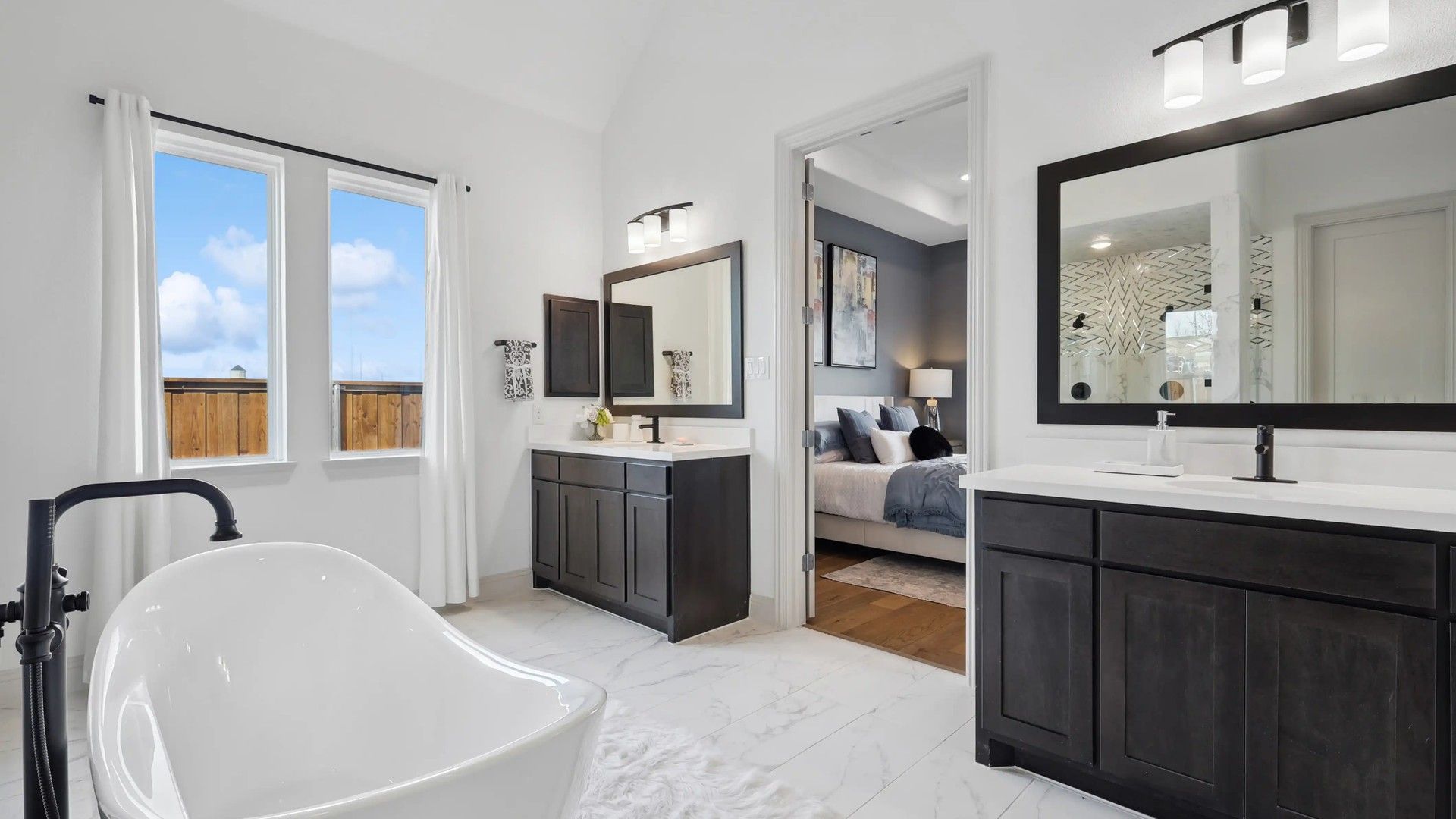 Luxurious bathroom features a sleek freestanding tub and dual vanities, exemplifying modern elegance in Westside Preserve.