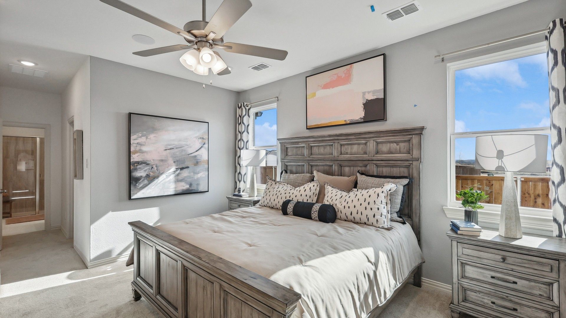 Experience sophistication with elegant woodwork and art in this Bel Air Village bedroom.