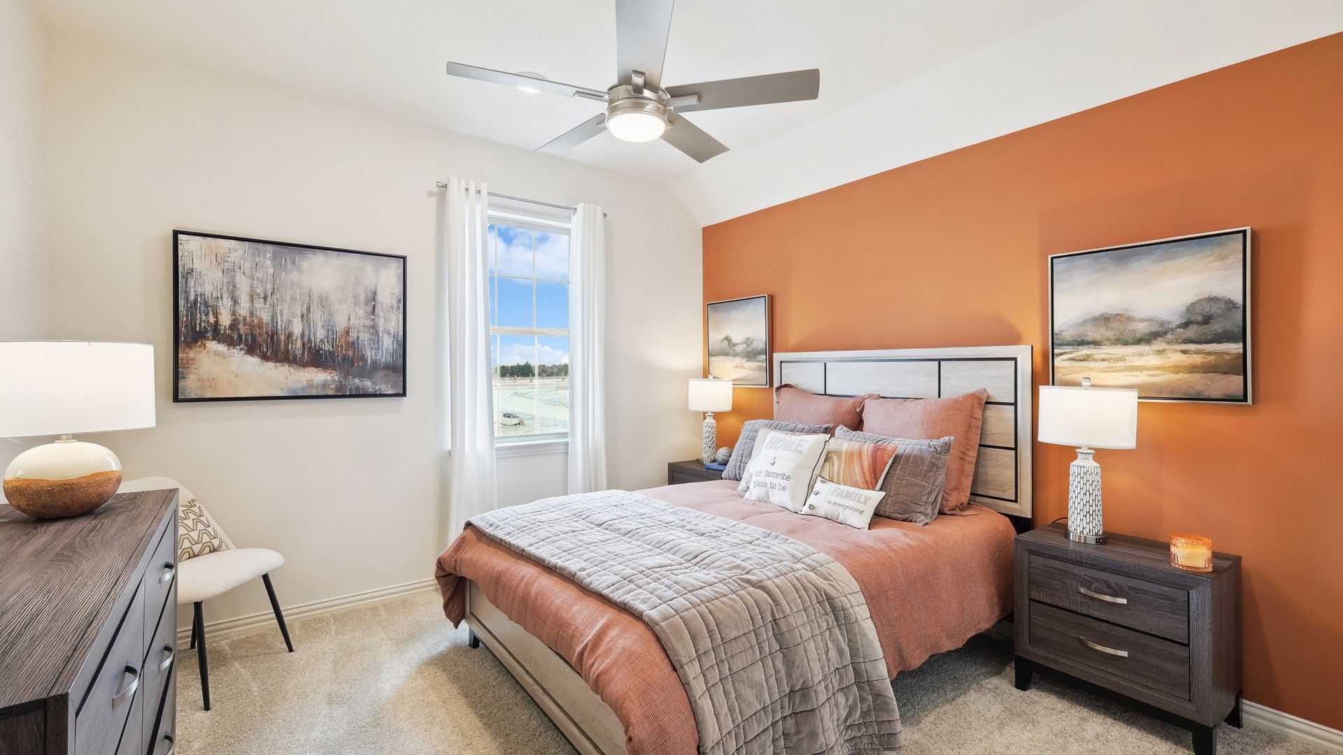 The Oaks' bedroom features elegant orange accents and sophisticated decor for premium comfort.