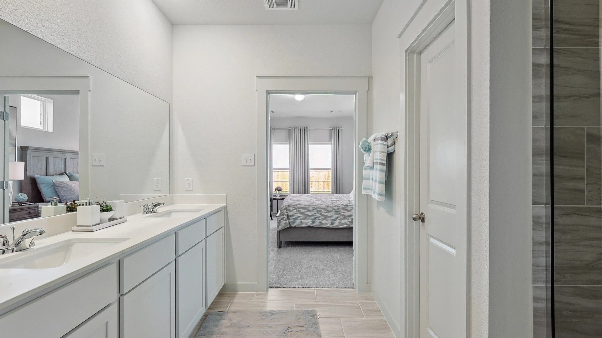 Luxurious double vanity bathroom with sleek cabinetry and premium finishes in Patriot Estates.