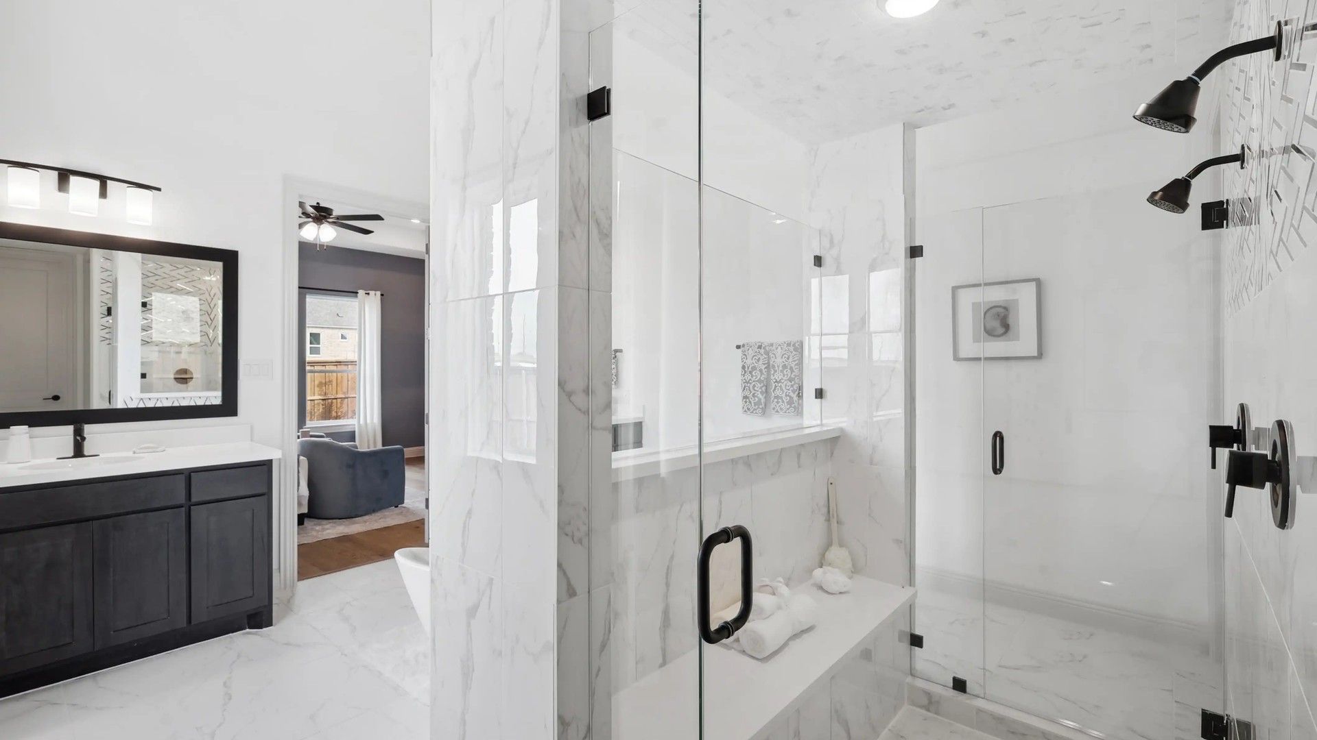 Experience marble elegance with a glass shower and refined wood cabinetry in Westside Preserve.