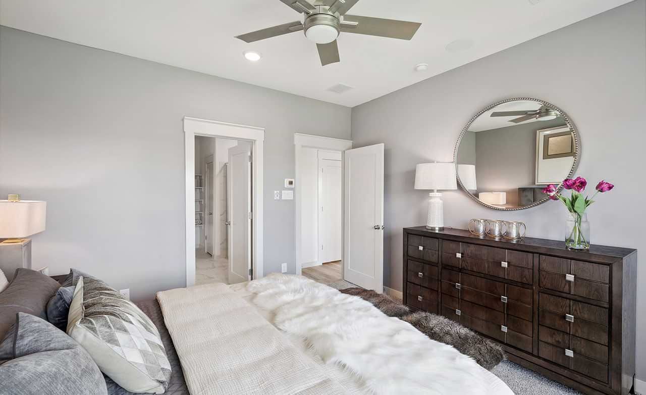Revel in a timeless walnut dresser, plush bedding, and chic ceiling fan in Walden Pond's exclusive enclave.