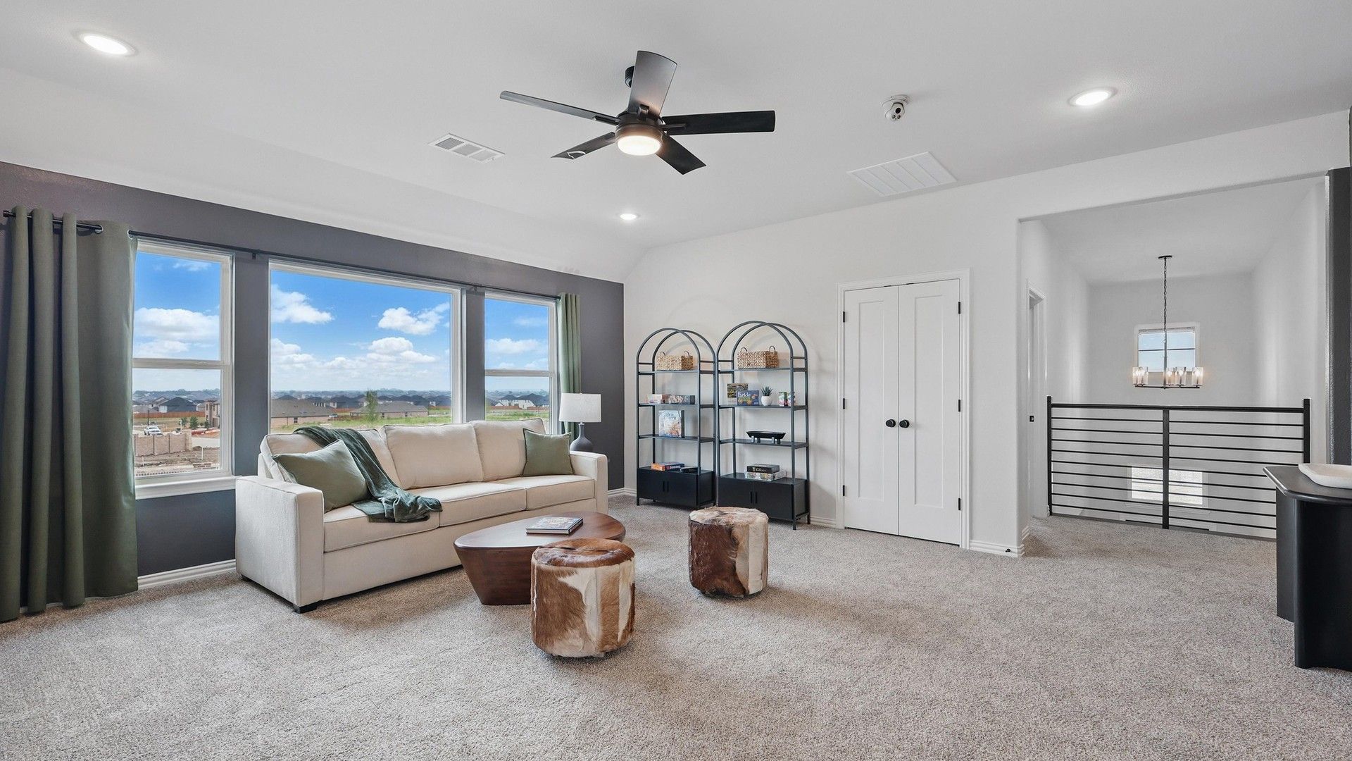 Luxurious lounge with plush carpet, expansive windows, and chic decor in Westridge community.