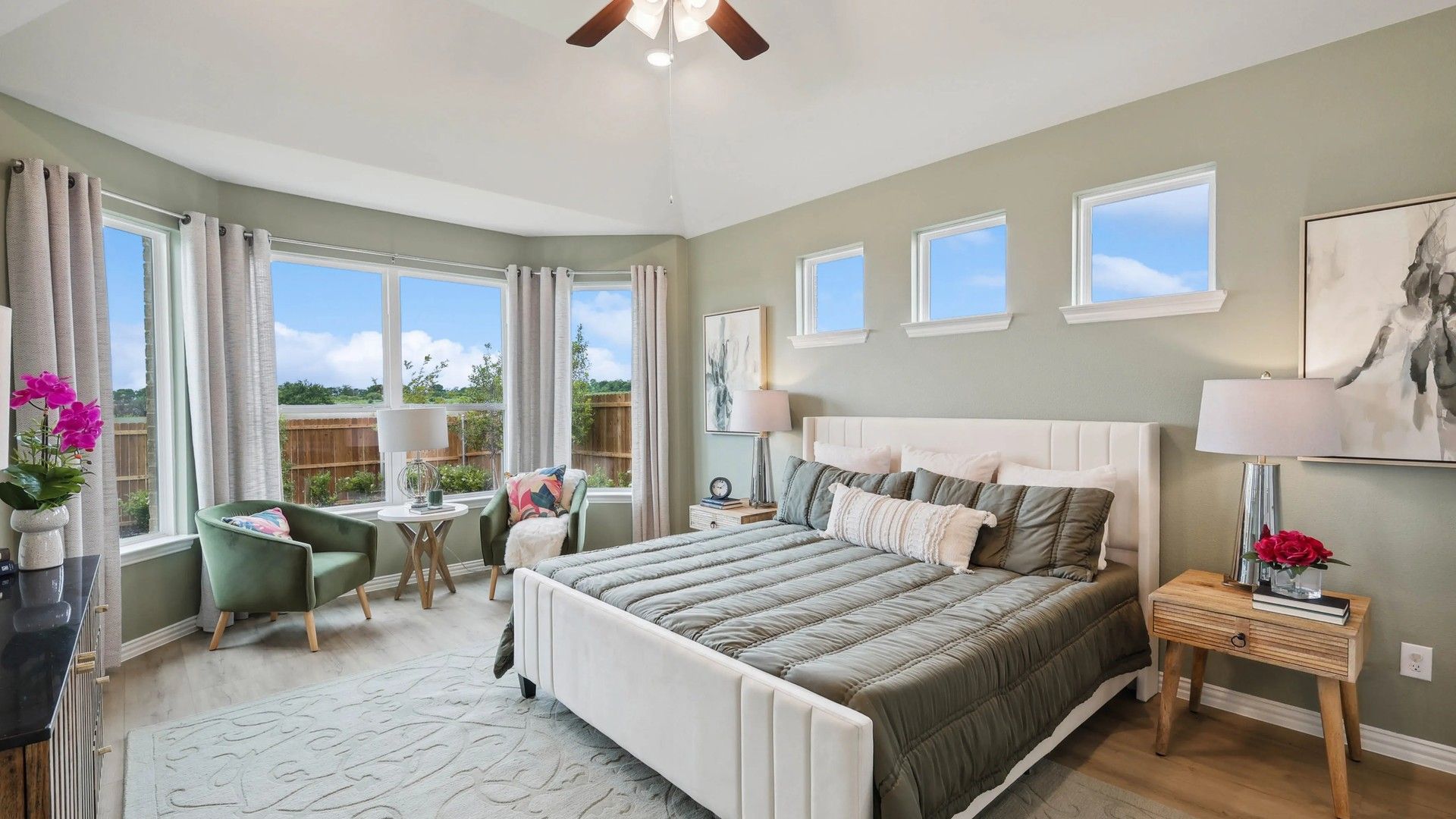 Vaulted ceilings and expansive bay windows enhance this Hulen Trails bedroom's sophisticated charm.