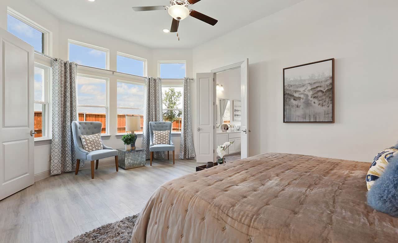 Experience elegance in this Thompson Farms bedroom, featuring expansive windows and sophisticated décor.