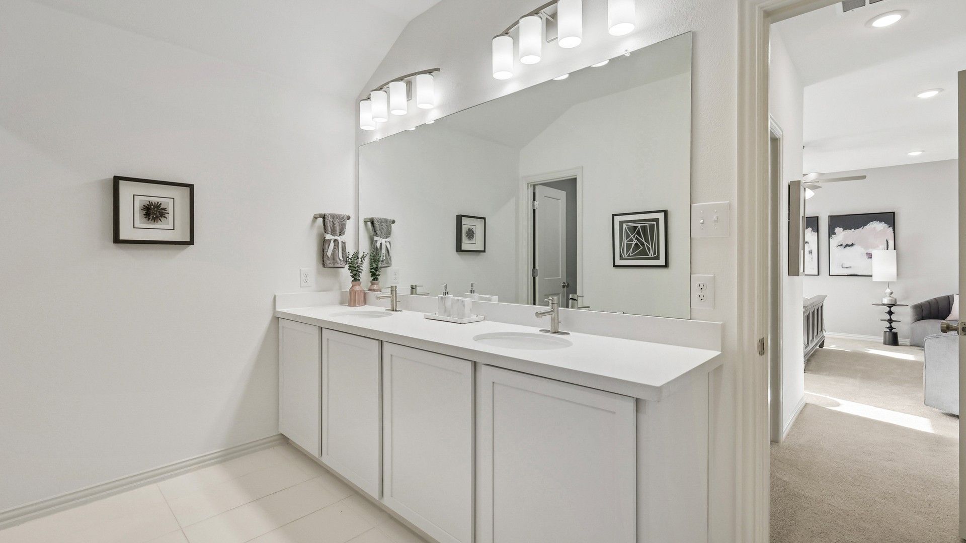 Luxurious dual vanity bathroom with sleek white cabinetry and contemporary lighting in Bel Air Village.