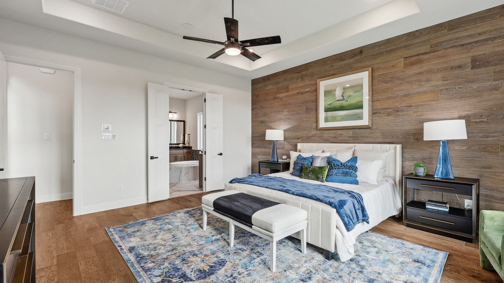 Exquisite wood-paneled accent wall elevates modern bedroom in Green Meadows. Luxurious details throughout.
