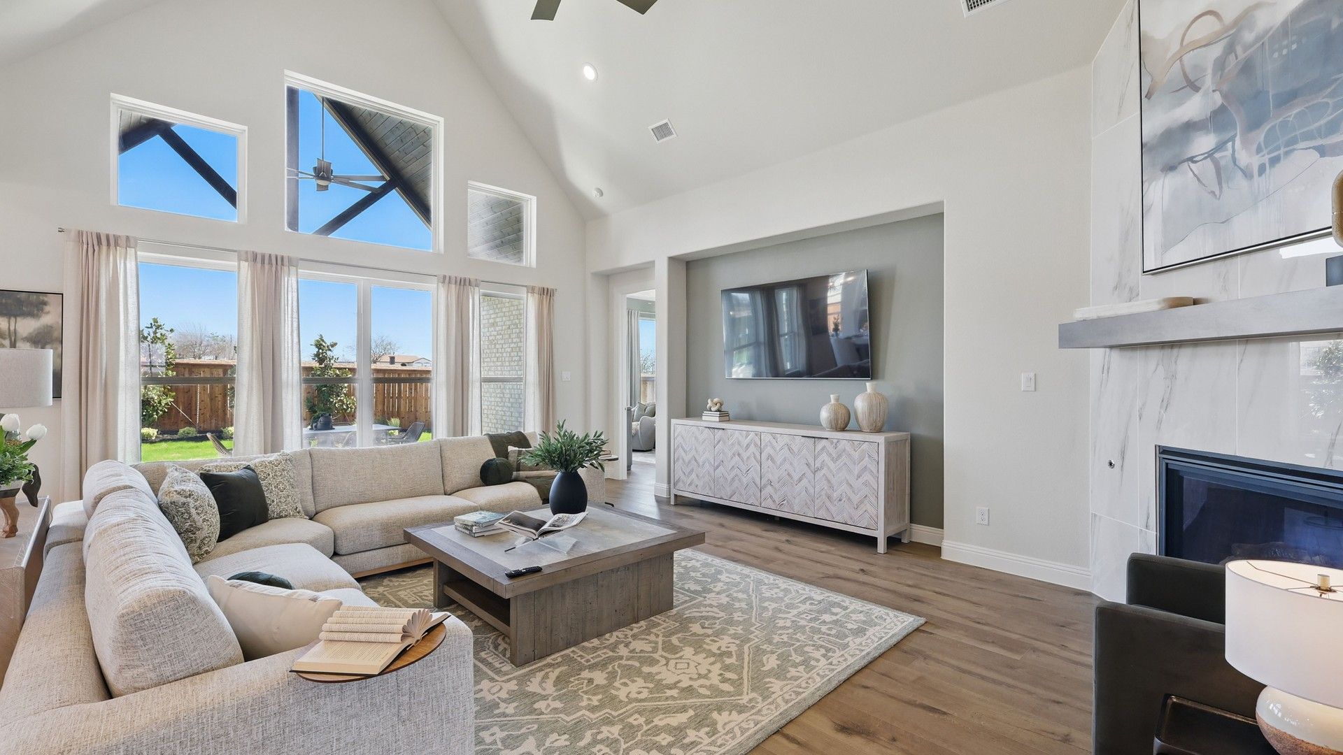 Luxurious living room features vaulted ceilings, elegant fireplace, and chic decor. Rio Vista at Kelly Ranch.