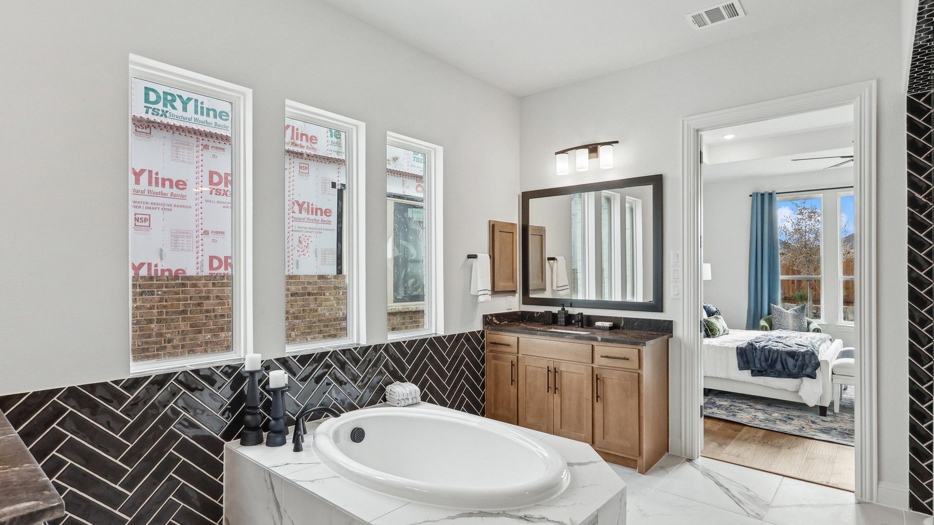 Exquisite marble tub and elegant herringbone tile accent in Green Meadows' luxury home.