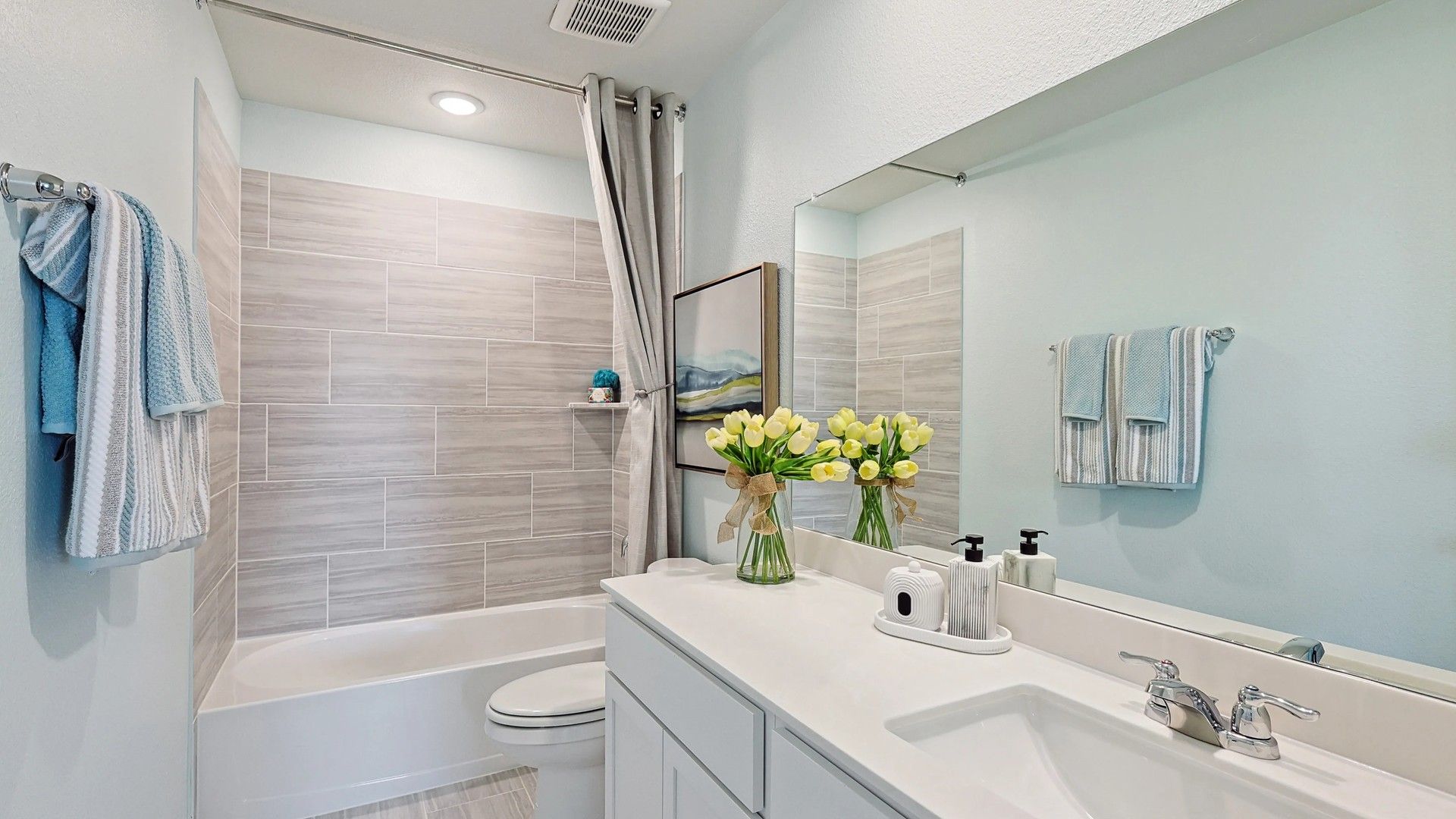 Luxurious bath with sleek tiles and minimalist fixtures, elevating charm in Patriot Estates.