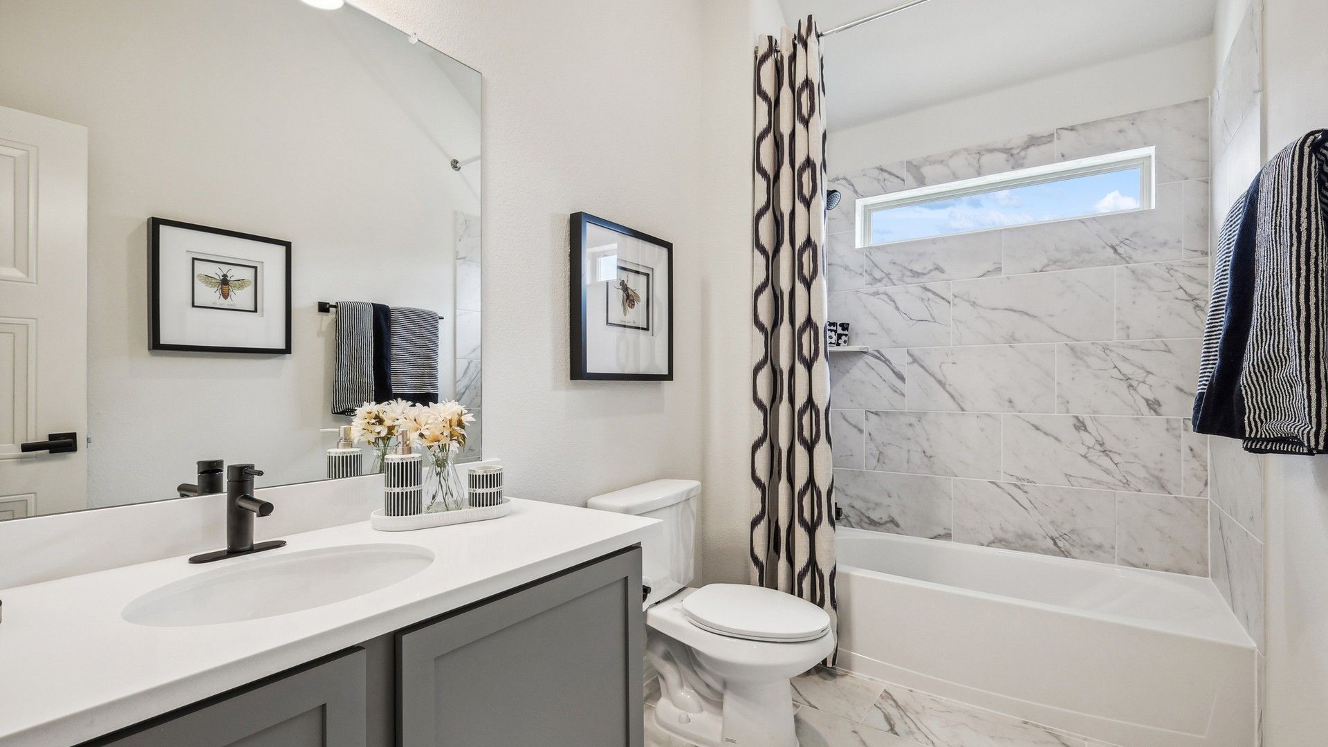 Luxurious marble tile bathroom featuring sleek fixtures in the exclusive Churchill community.